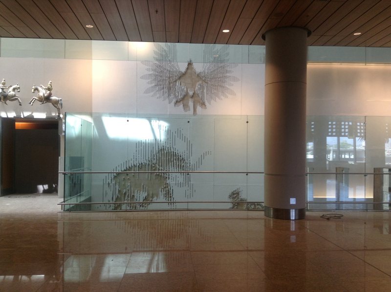 Glass panels with animal figures in an airport hall