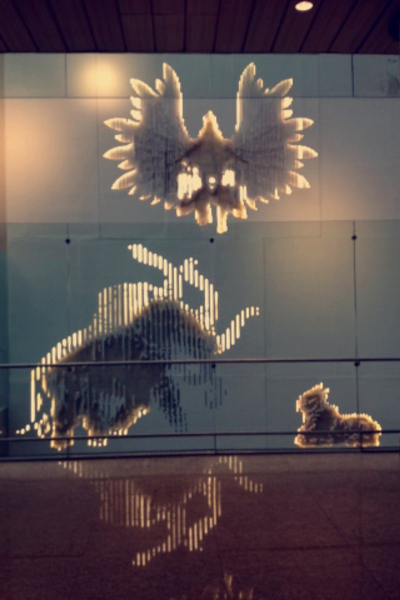Close view of glowing animal figures on the glass panels
